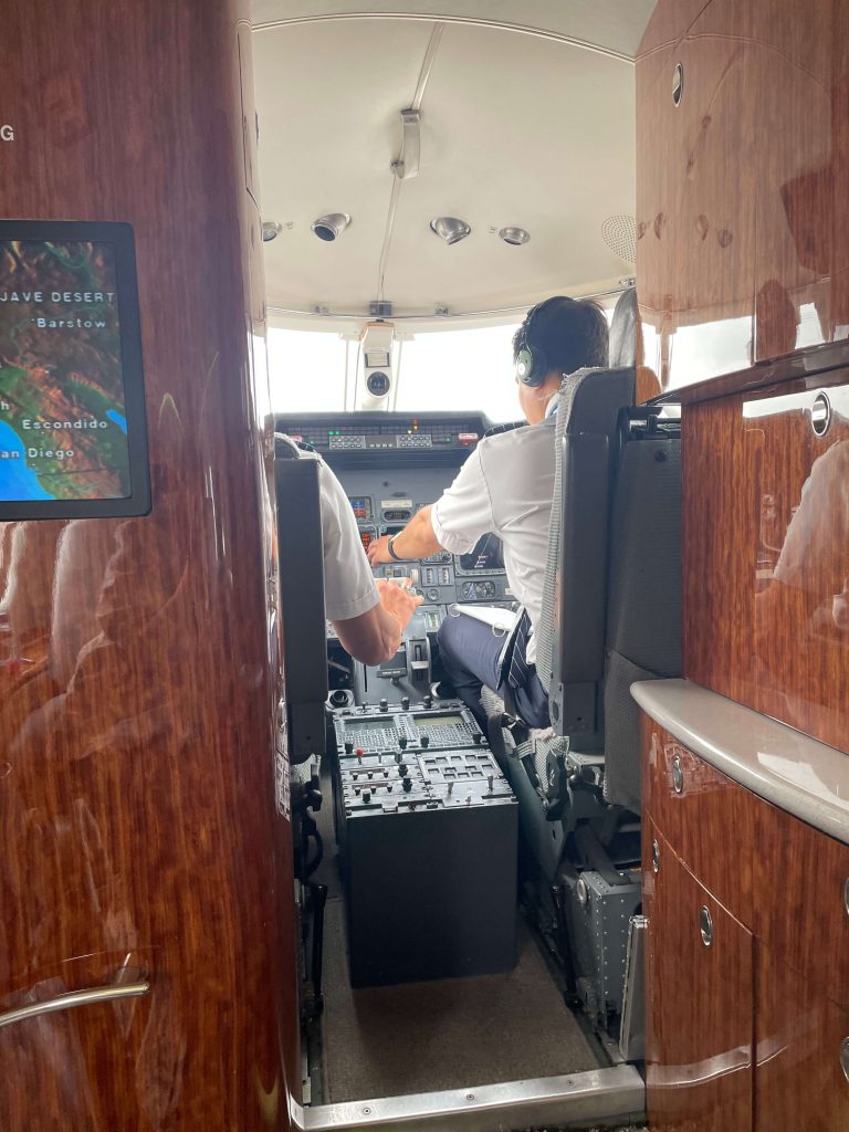 Pilot flying over California vineyards on a Private Jet Napa Valley route for wine travel